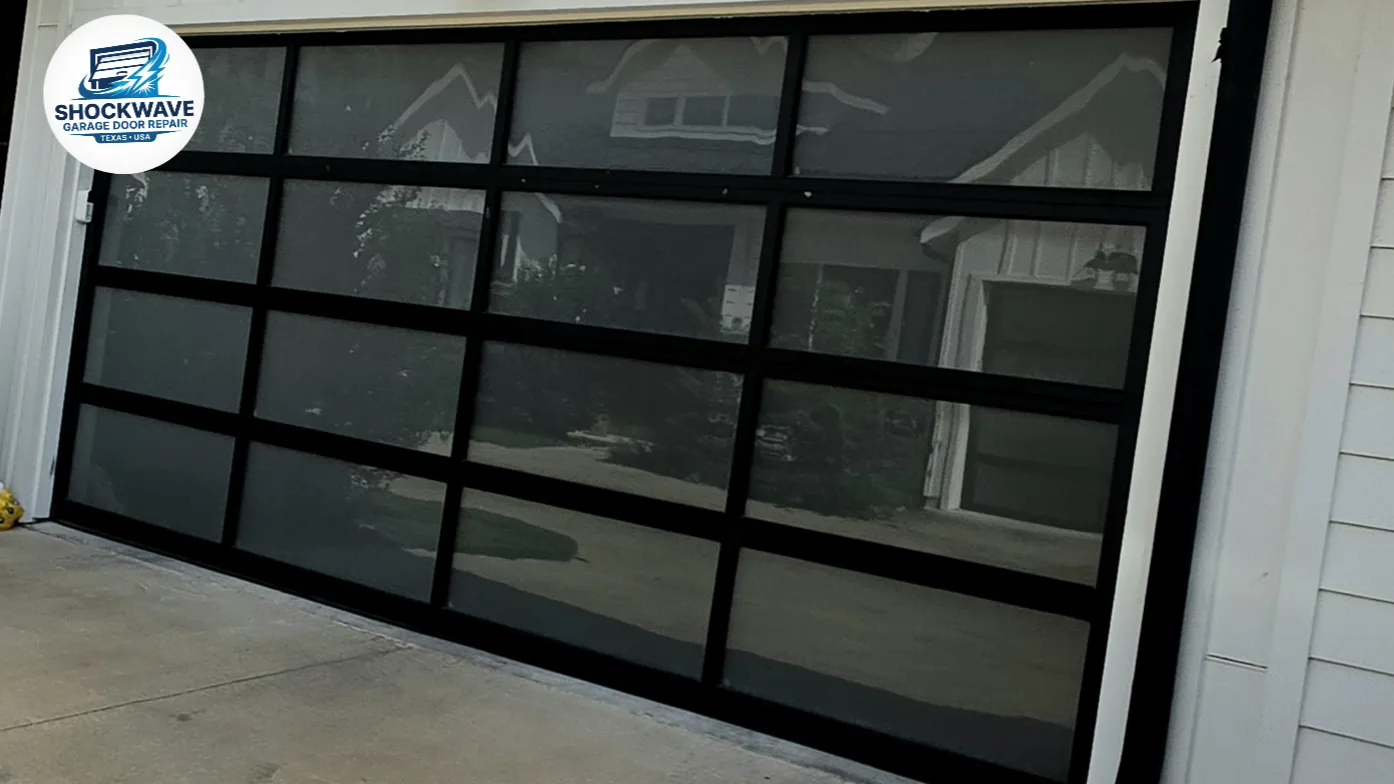 Black full-view glass garage door on a residential home in Shockwave's Austin-area work gallery.
