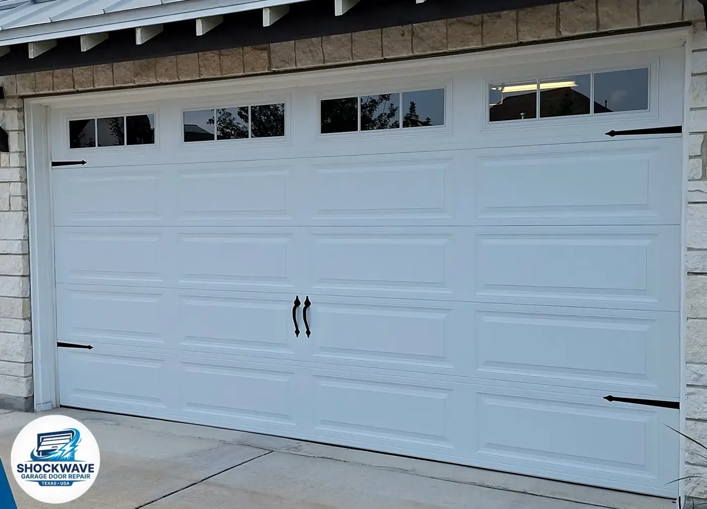 White carriage-style garage door with top-row windows in the homepage hero.